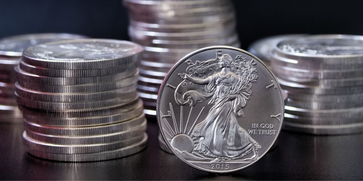 A 2015 Silver Eagle against a backdrop of stacks of Silver Eagles